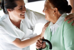 Happy young nurse with an old patient