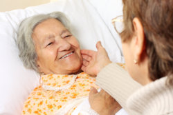 Senior woman lying in bed