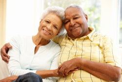 Senior African American couple at home. Camera, people.